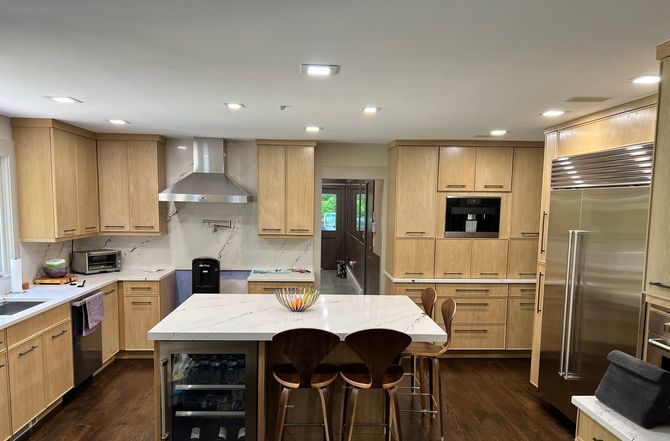 Wide kitchen interior with newly installed wooden cabinets