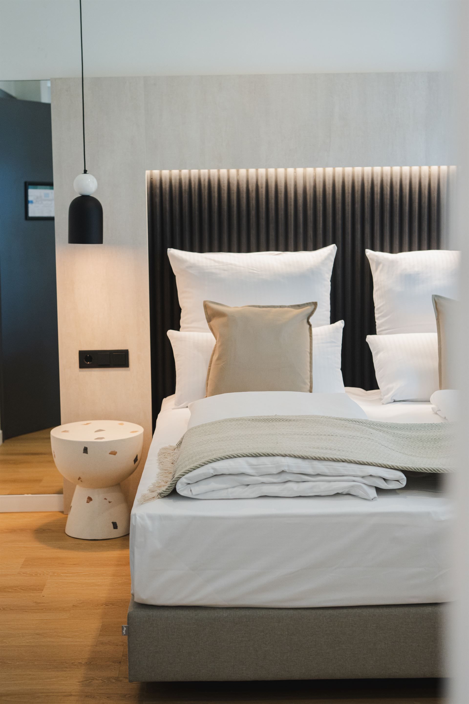 Cozy bedroom with contemporary furnishings and natural light.