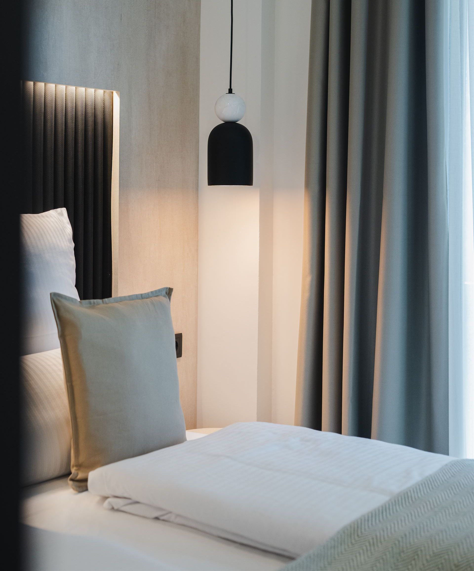 Cozy bedroom with contemporary furnishings and natural light.
