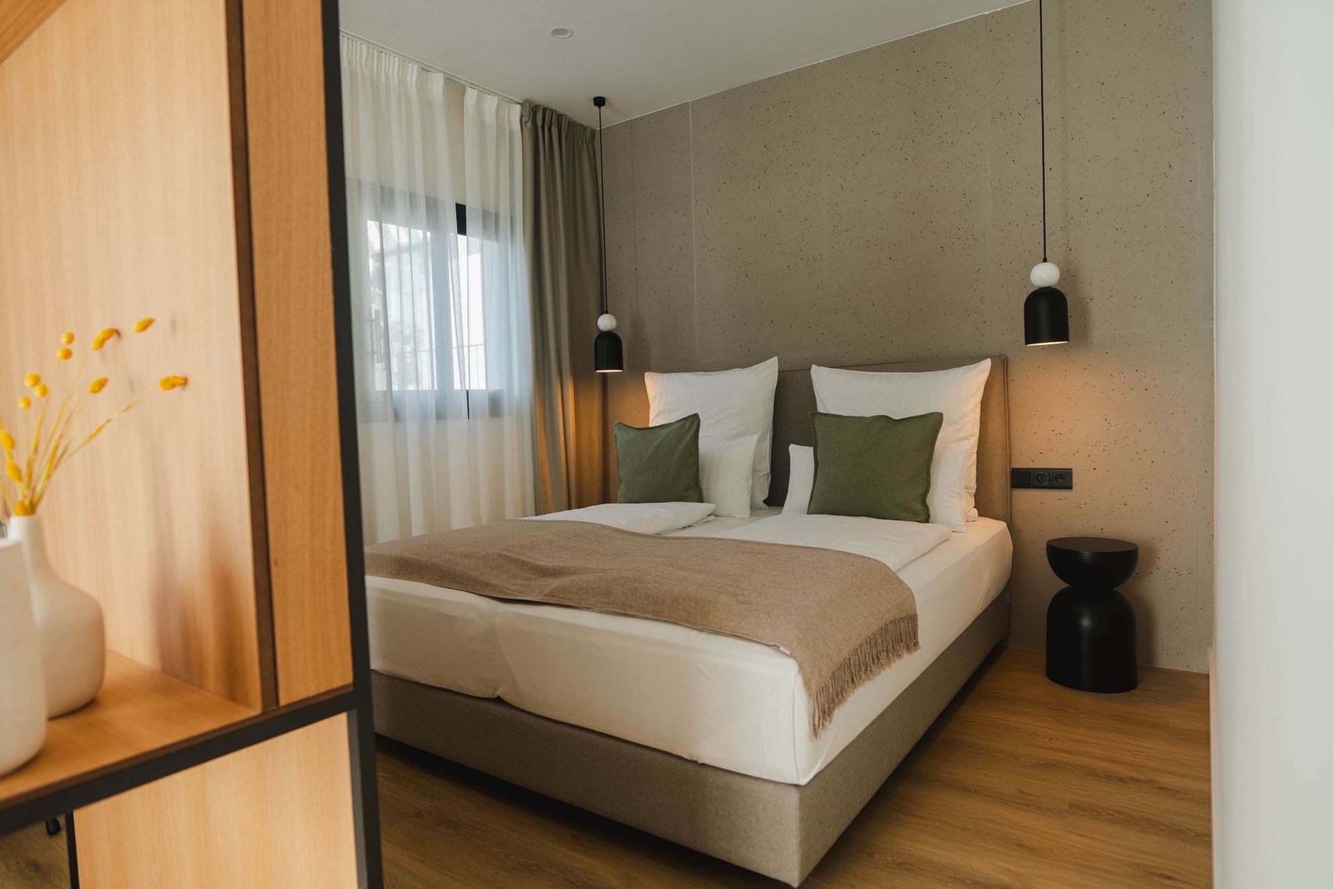 Comfortable hotel room with bed, bedside tables, and modern decor.
