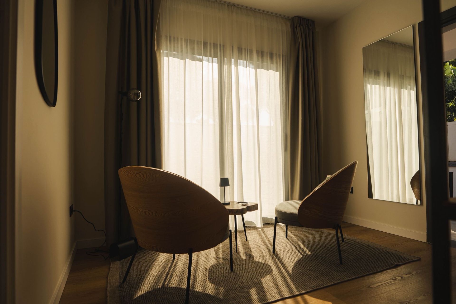 Cozy sitting area inside a room with chairs and a small table.