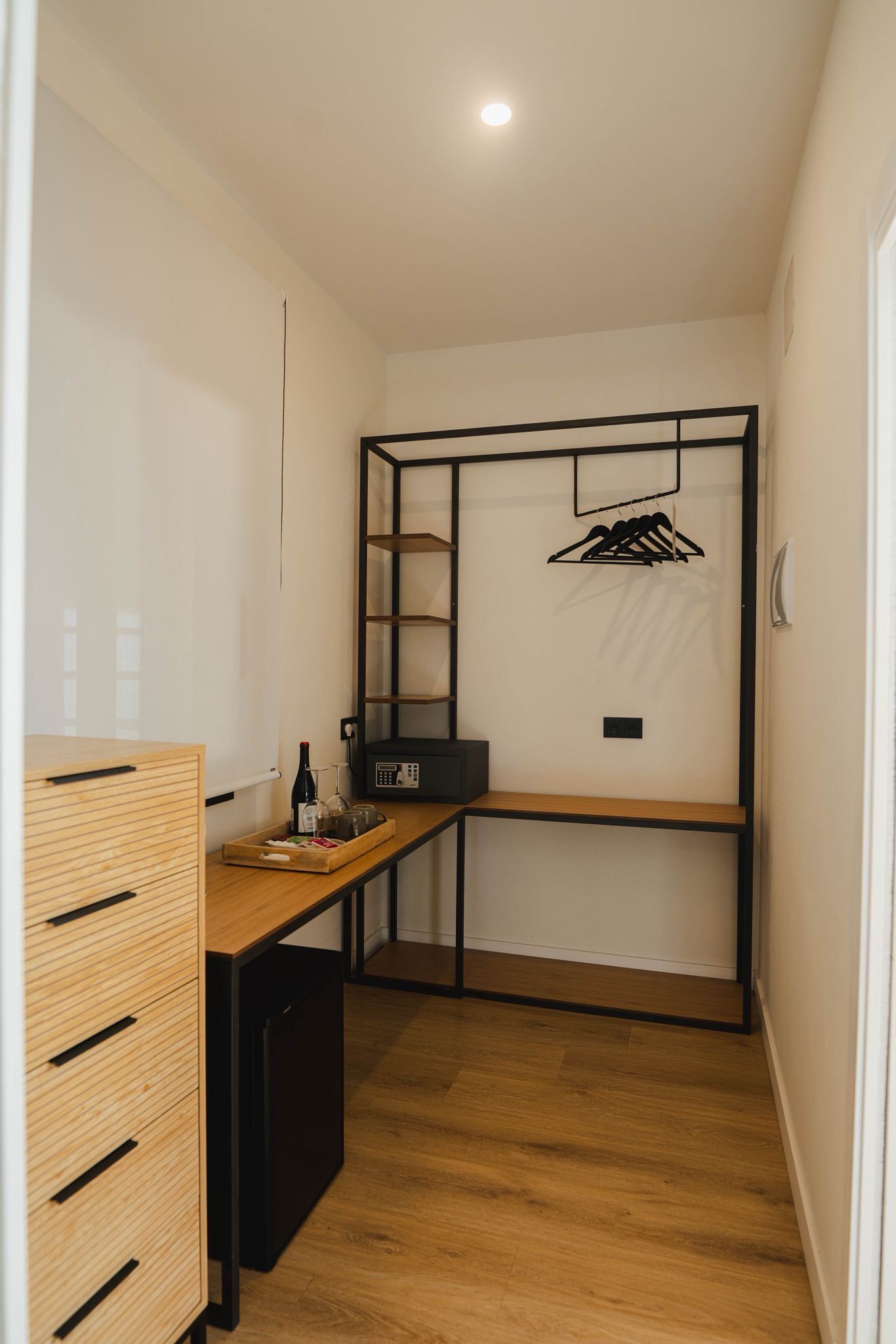 Modern guest room with a clean design and a small workspace.