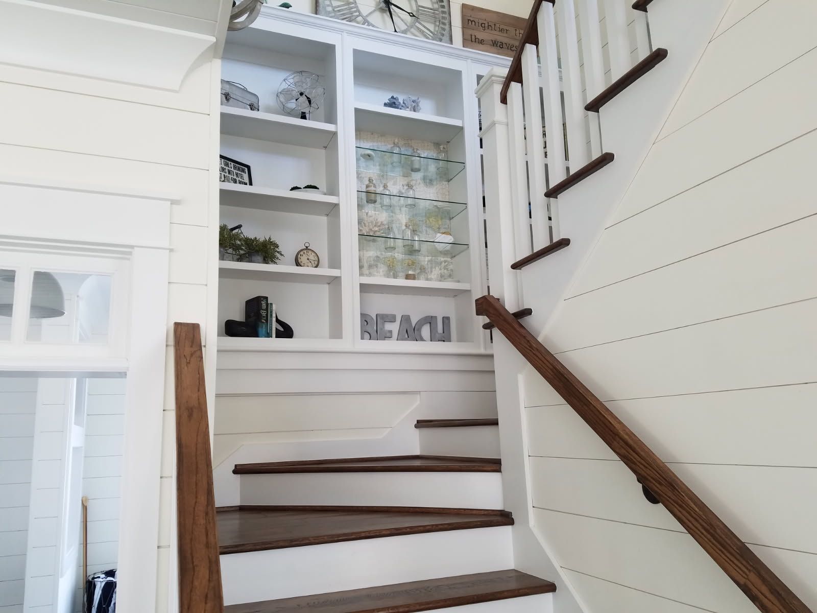 A set of stairs leading up to a shelf with a sign that says nemo on it