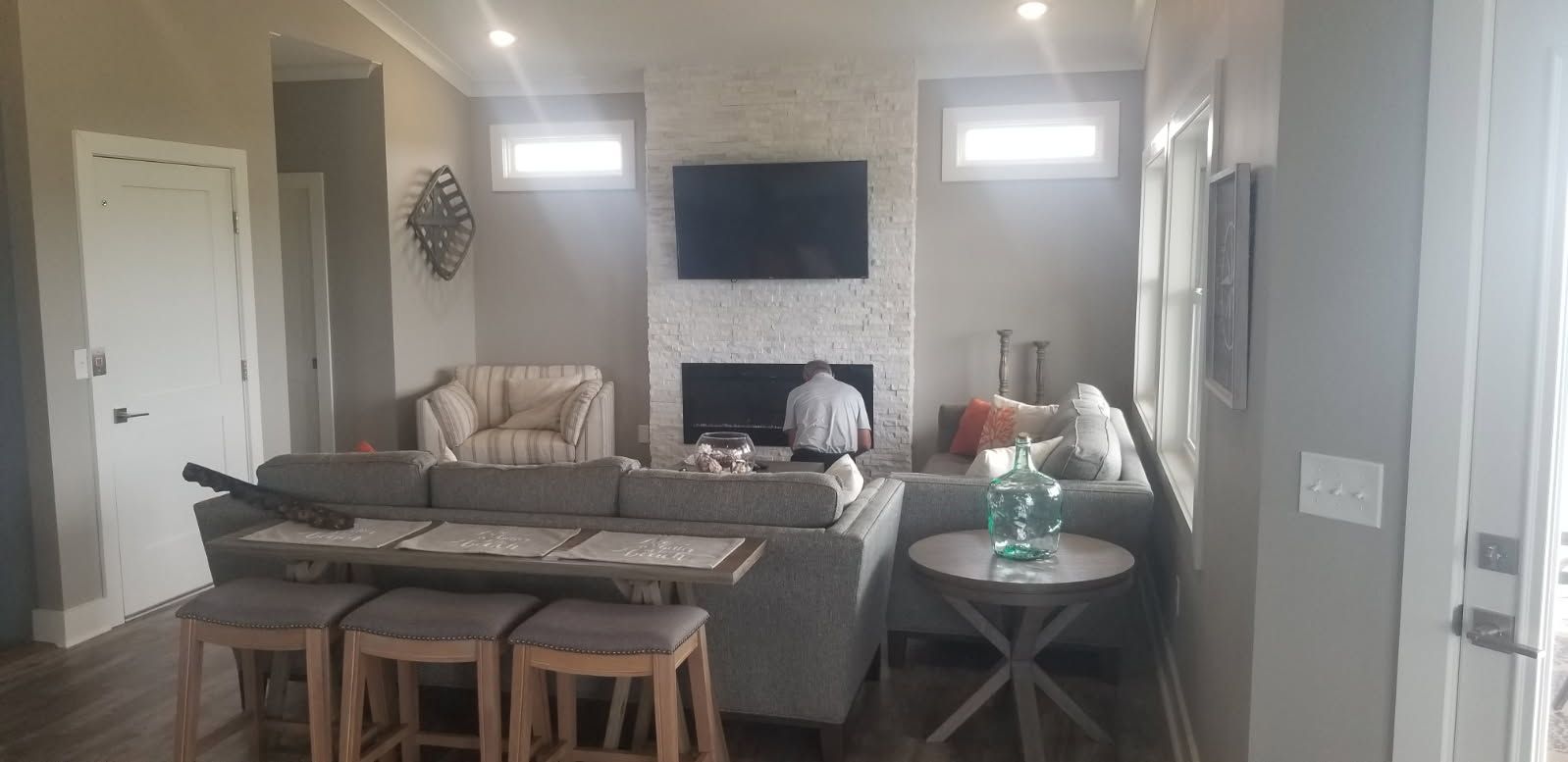 A living room with a couch , fireplace and television.