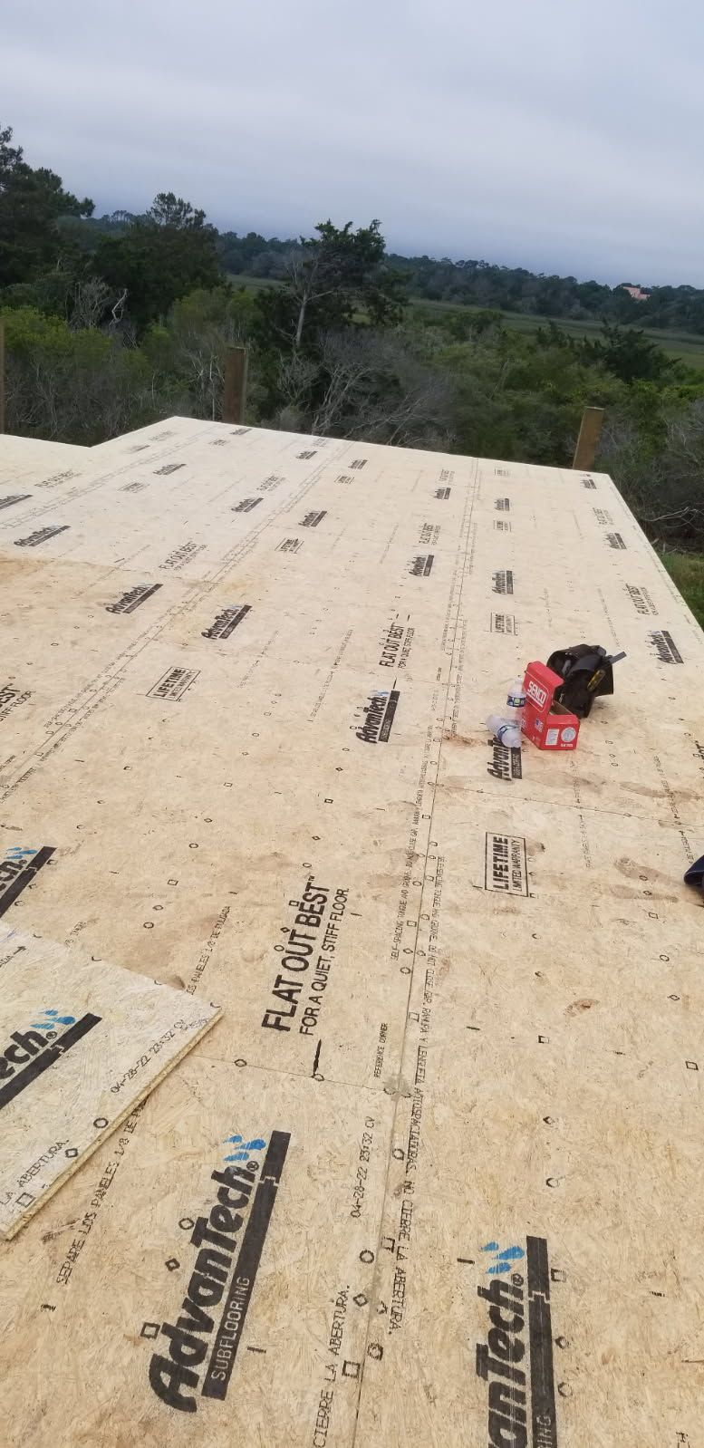 A roof is being built with plywood and a drill.