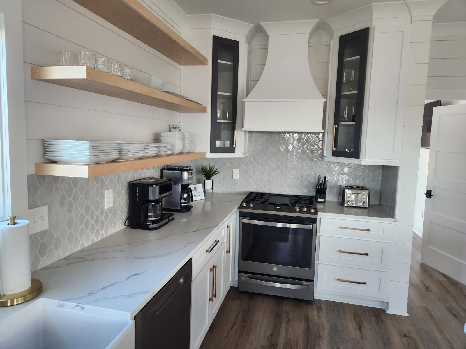 A kitchen with white cabinets and stainless steel appliances