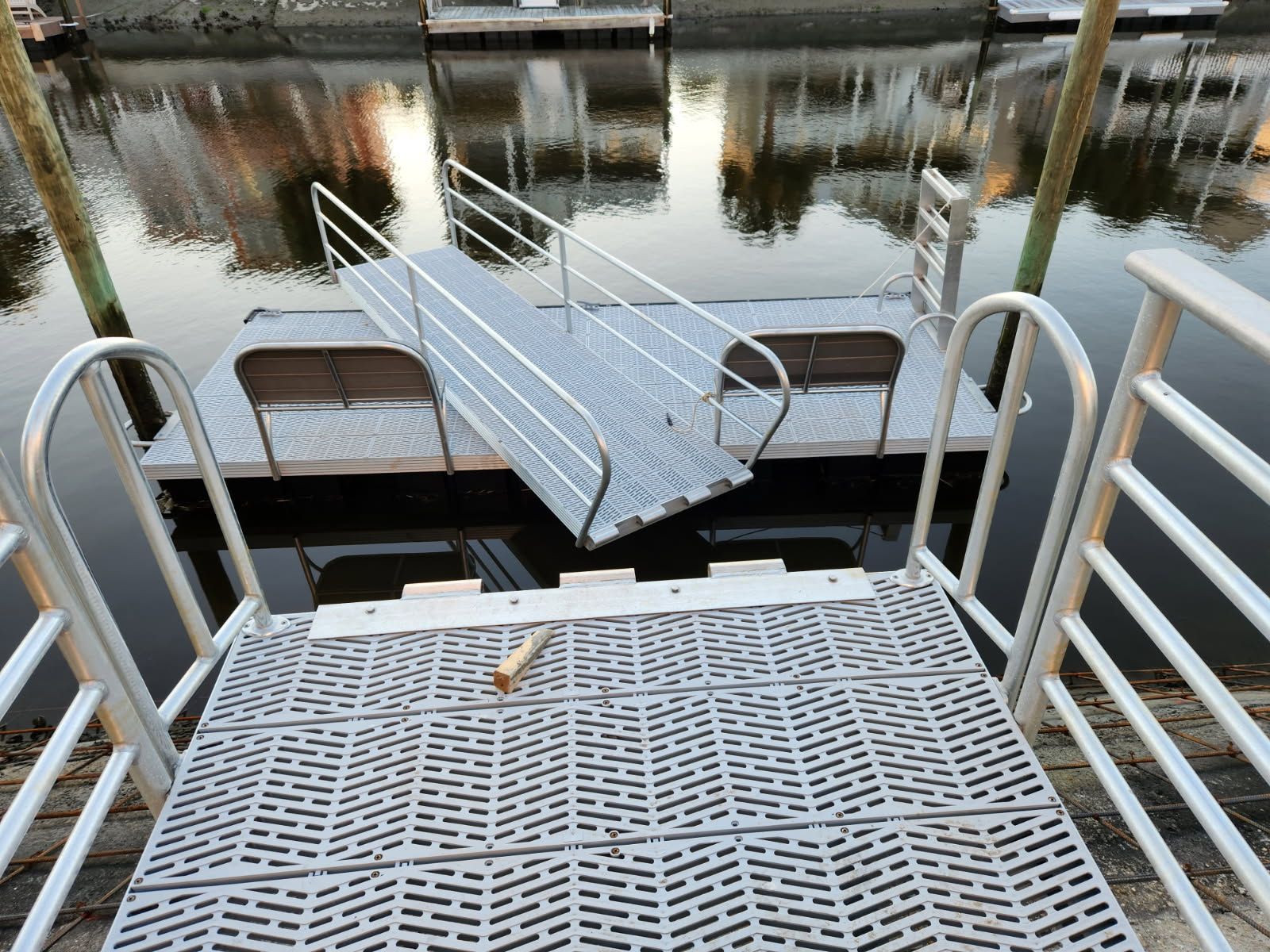 A dock with stairs and a ramp leading to the water