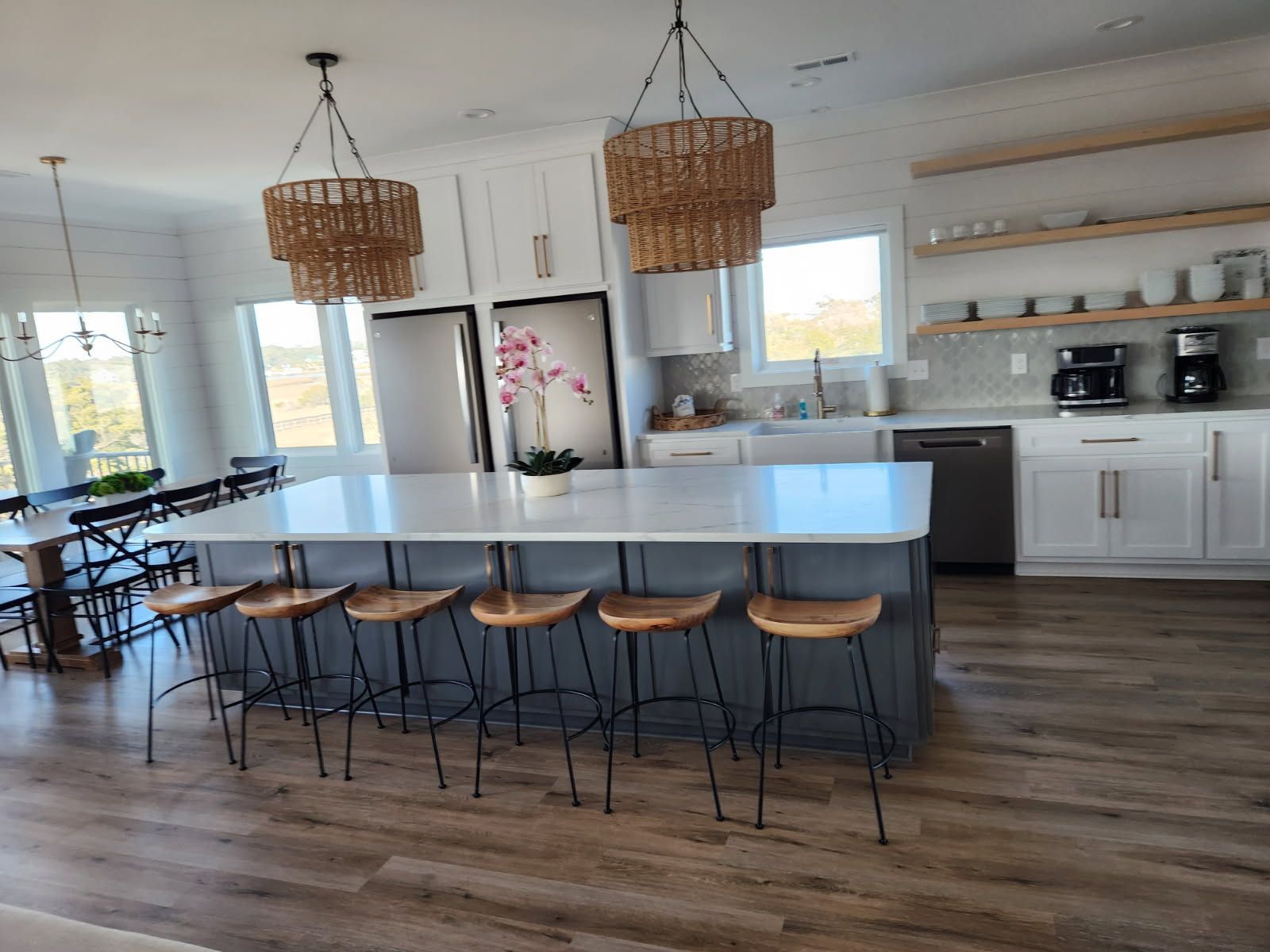 A kitchen with a large island and stools
