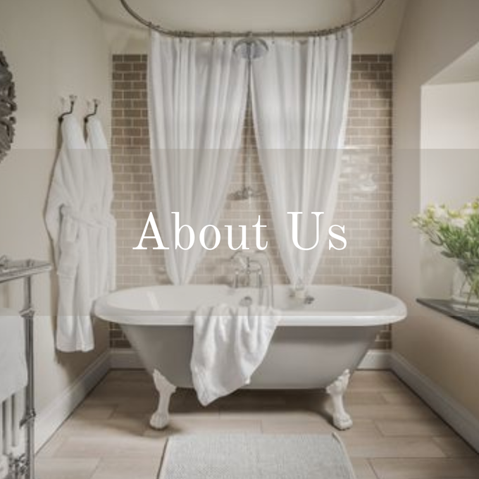white roll top bath with white dressing gowns hanging up and white towel over the side