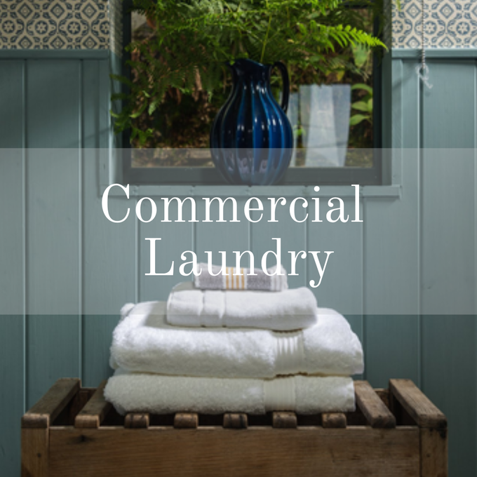 white towels on brown wood table with blue panelling behind
