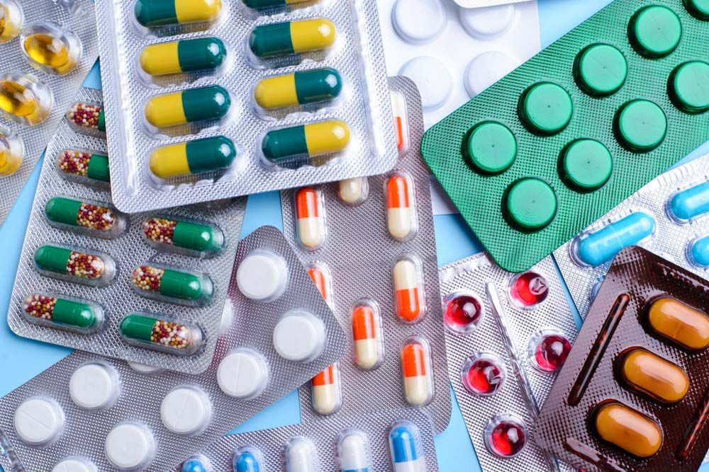 A Pile of Pills and Capsules on a Blue Surface — Northern Beaches GP Superclinic in Deeragun, QLD