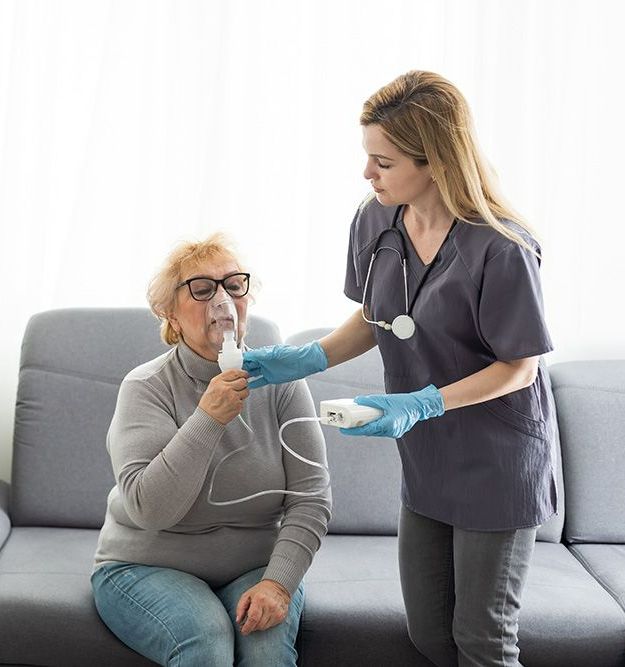 A Nurse is Giving an Older Woman an Oxygen Mask — Northern Beaches GP Superclinic in Deeragun, QLD