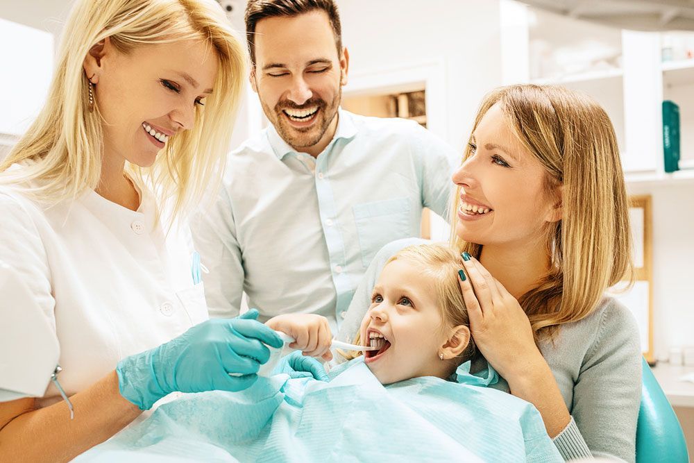 Little Girl in Dental Chair With Parents During a Dental Exam — Northern Beaches GP Superclinic in Deeragun, QLD