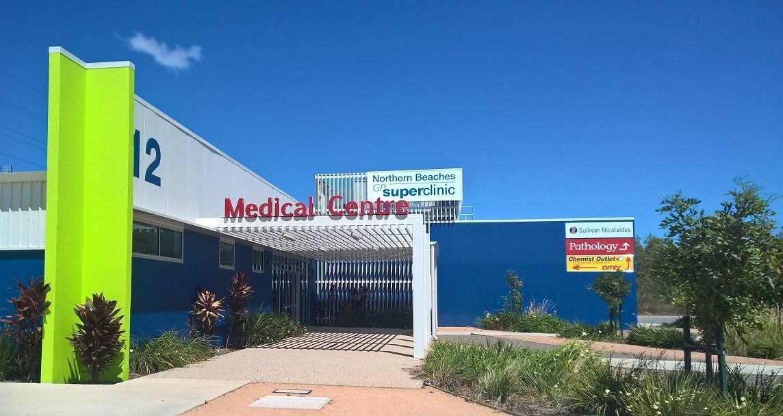 A Blue Building With a Red Sign That Says Medical Centre — Northern Beaches GP Superclinic in Deeragun, QLD