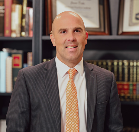 A man in a suit and tie is leaning on a railing