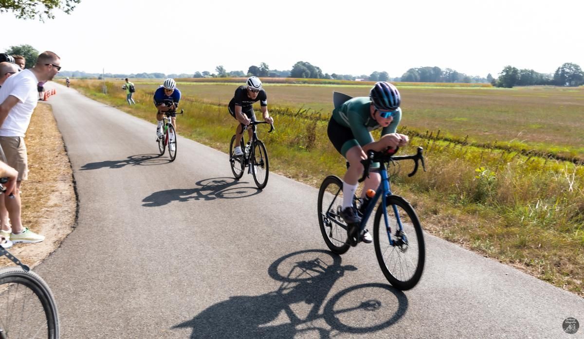 Een groep mensen fietst over een weg.