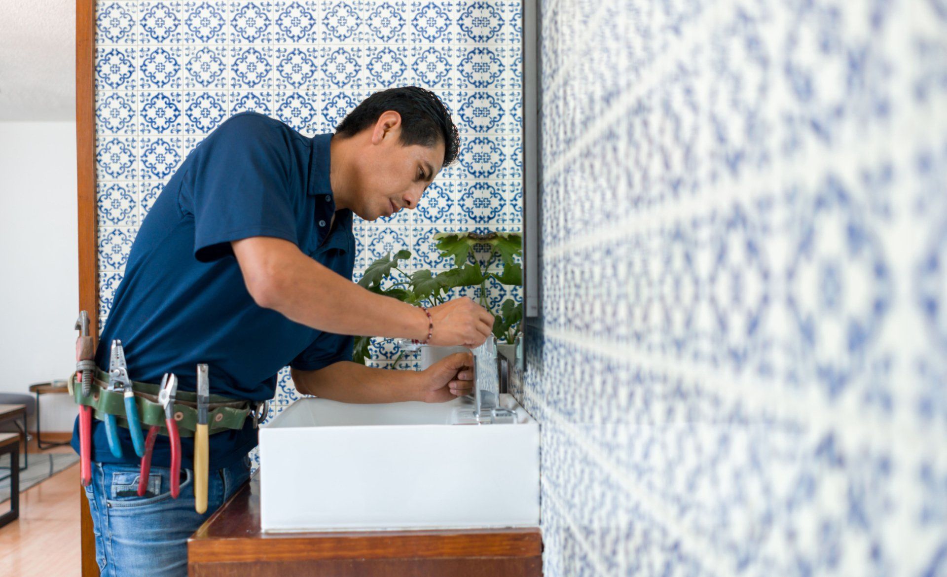 A Plumber Fixing A Faucet — Jersey City, NJ — United Jersey Plumbing & Heating A Plumber Fixing A Faucet — Jersey City, NJ — United Jersey Plumbing & Heating