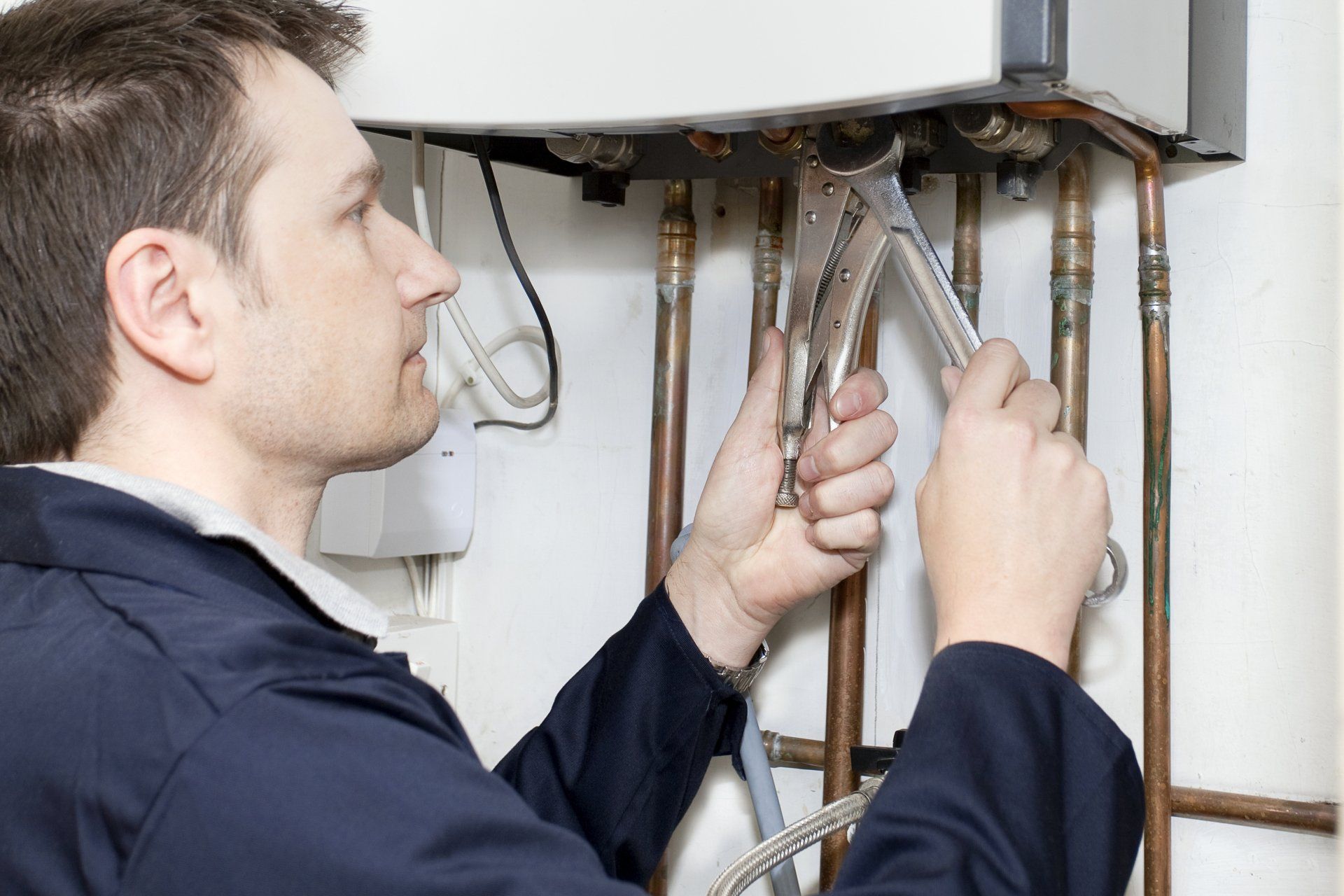 A Plumber Working On A Boiler — Jersey City, NJ — United Jersey Plumbing & Heating