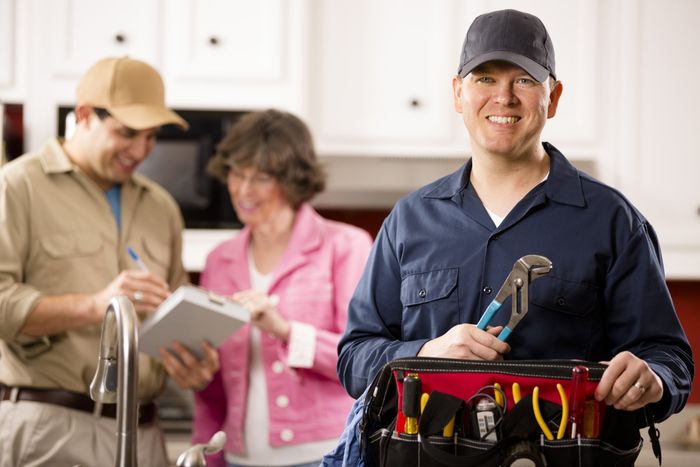 Smiling Plumbers And A Homeowner — Jersey City, NJ — United Jersey Plumbing & Heating Smiling Plumbers And A Homeowner — Jersey City, NJ — United Jersey Plumbing & Heating