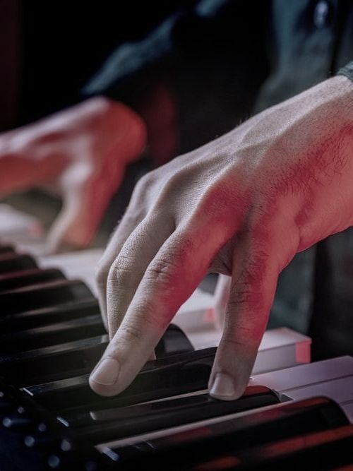 A Close Up Of A Person 's Hand Playing A Piano Keyboard — Doug Simpson Piano Tuning In Cairns, QLD