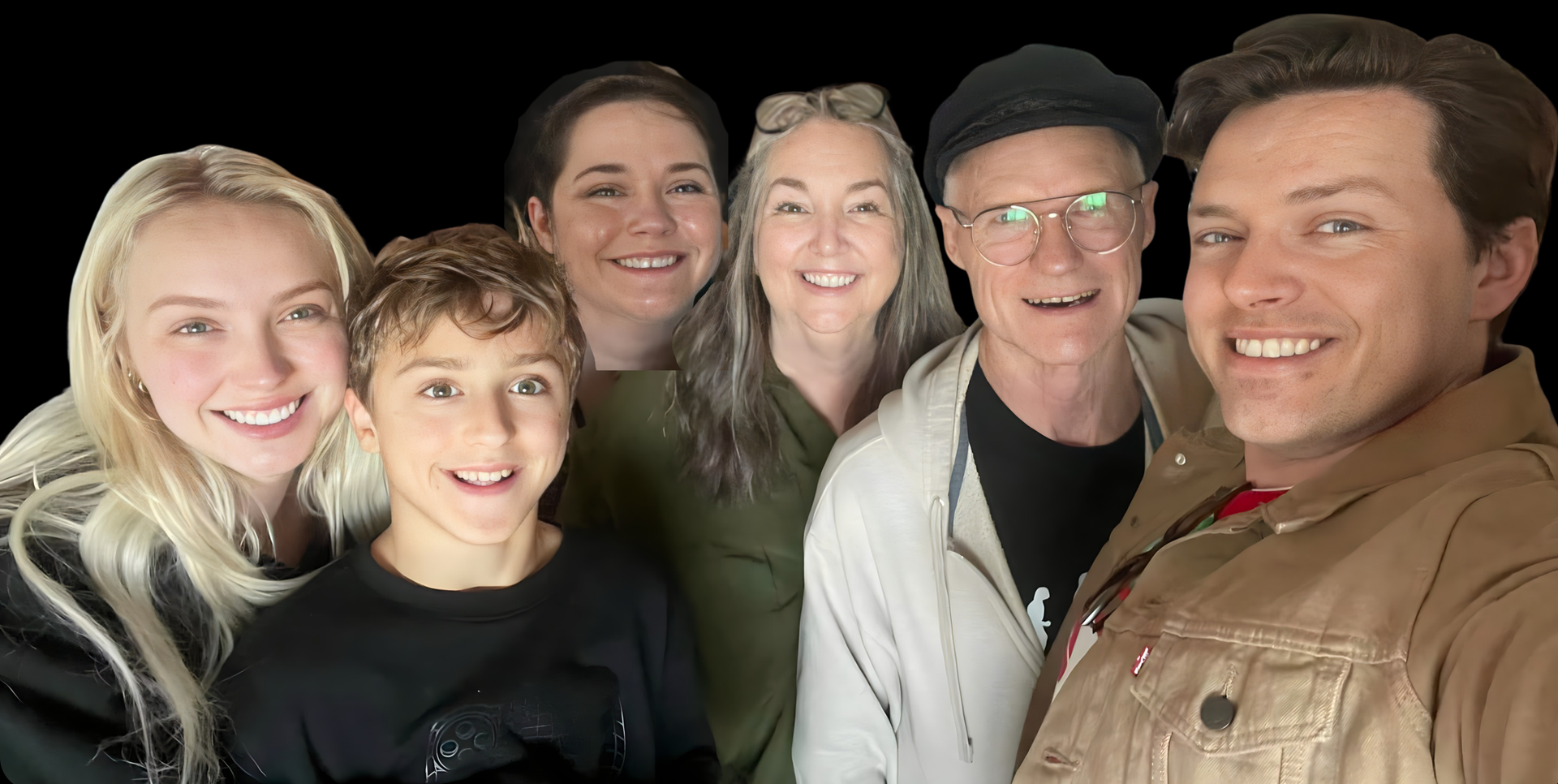 Six smiling people posing closely together indoors against a dark background.