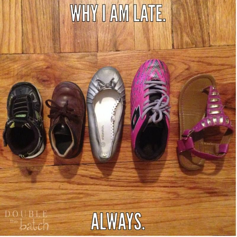 Five different shoes in a row on a wooden floor: baby shoe, brown shoe, silver flat, pink sneaker, studded sandal. Text: