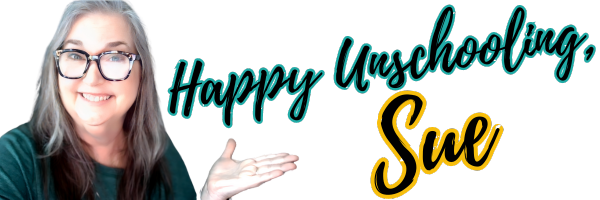 Woman with glasses smiling, pointing towards