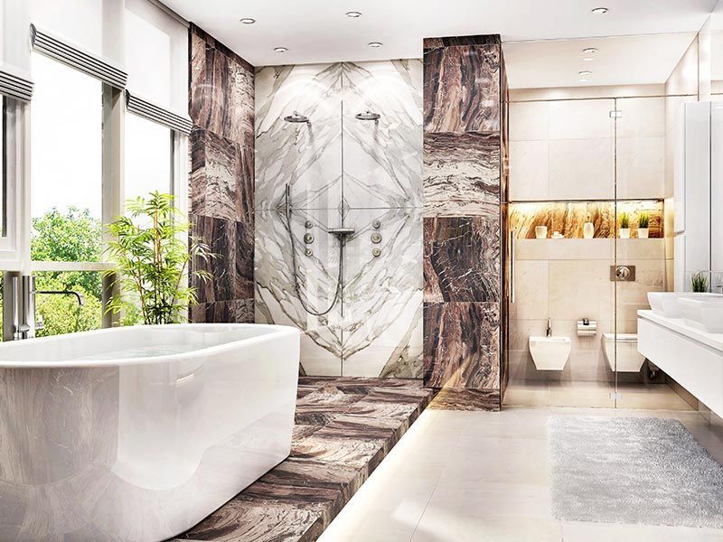 A modern bathroom with a freestanding white tub, a large marble-tiled shower, and a floating vanity under warm lighting.