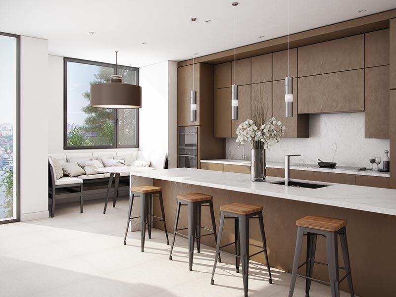 Modern kitchen with brown wood cabinetry, white countertops, four stools, and a dining nook near a large window.
