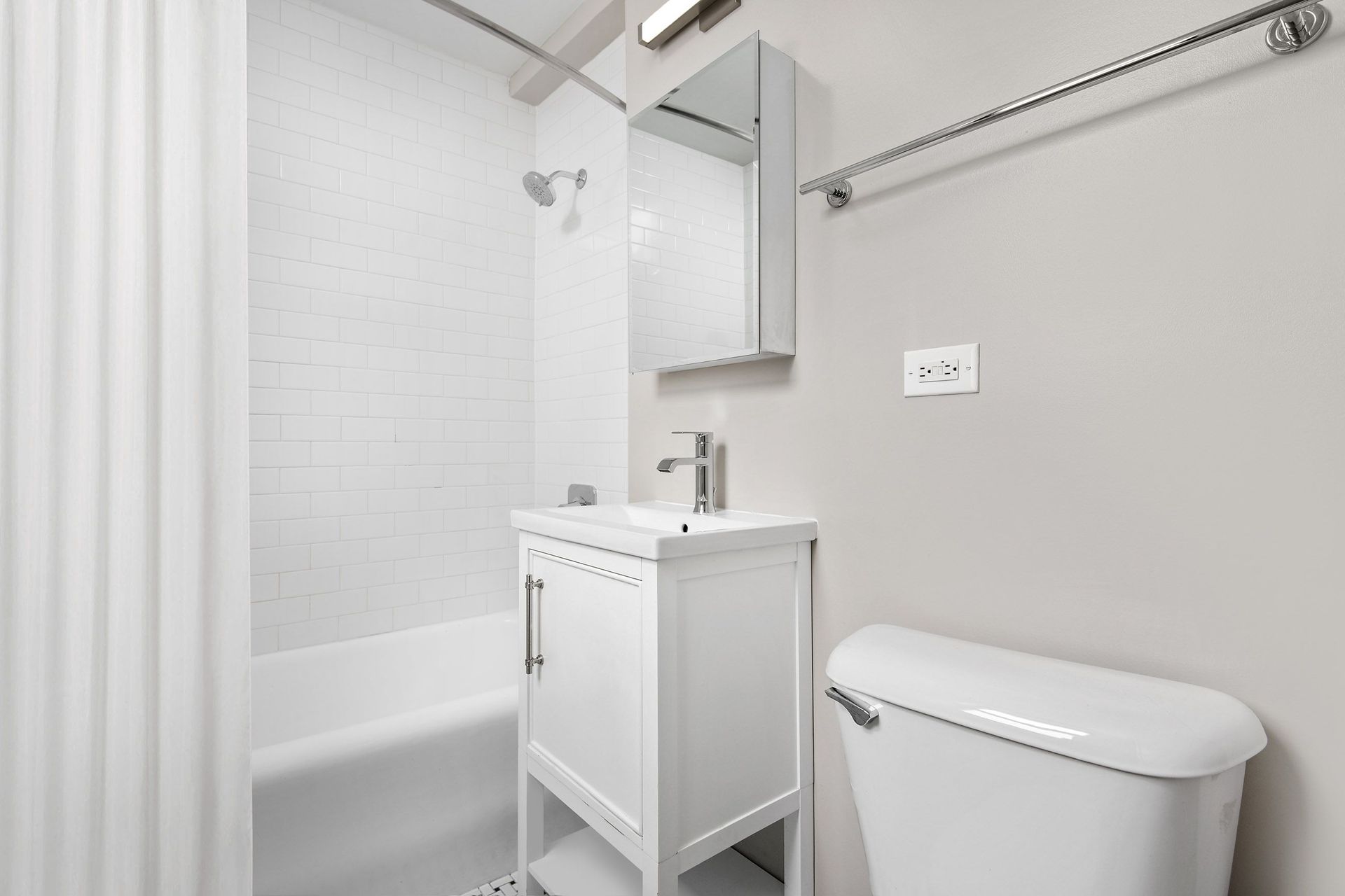 a bathroom with a sink and a toilet and a bath tub