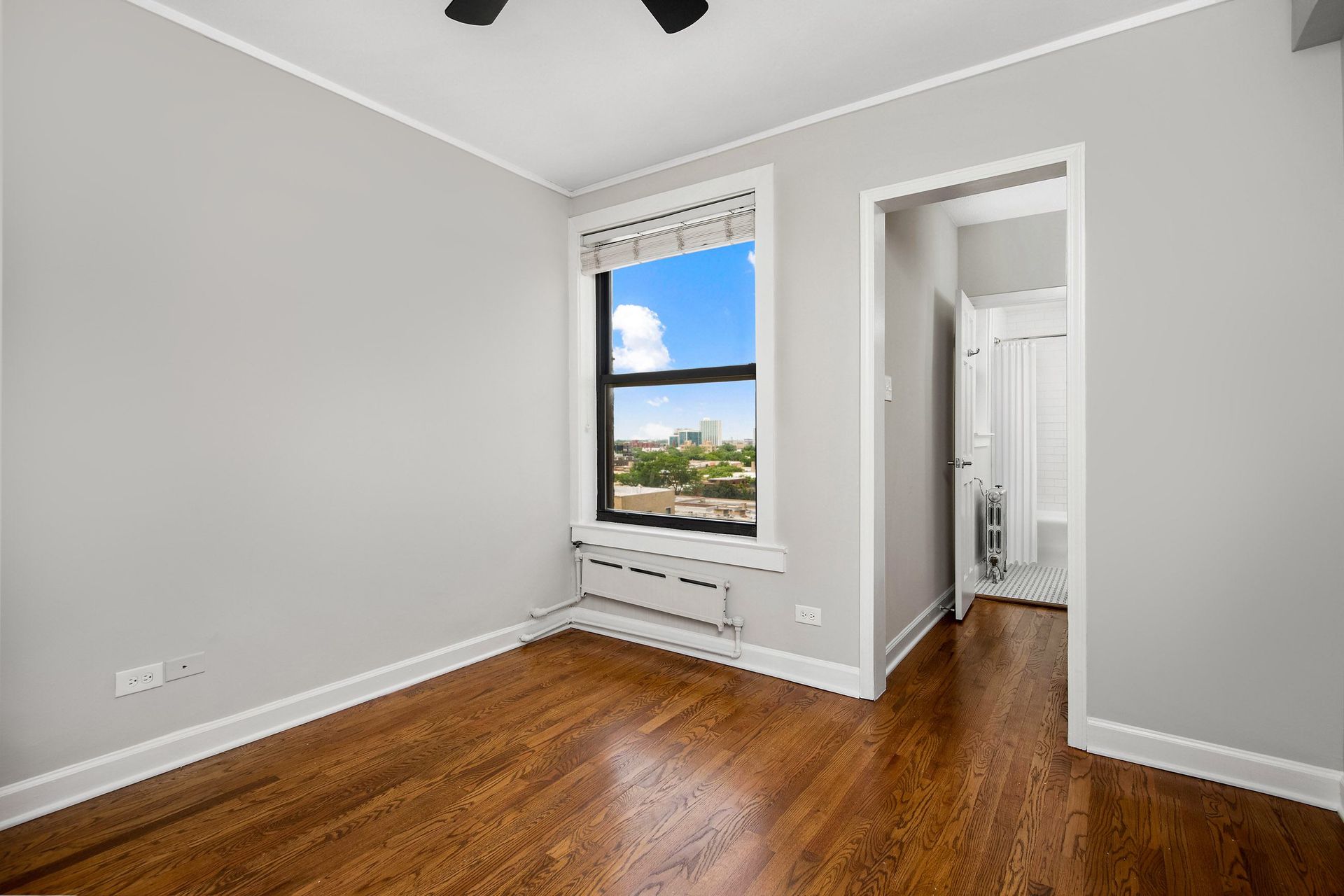 a living room with wood floors and a window