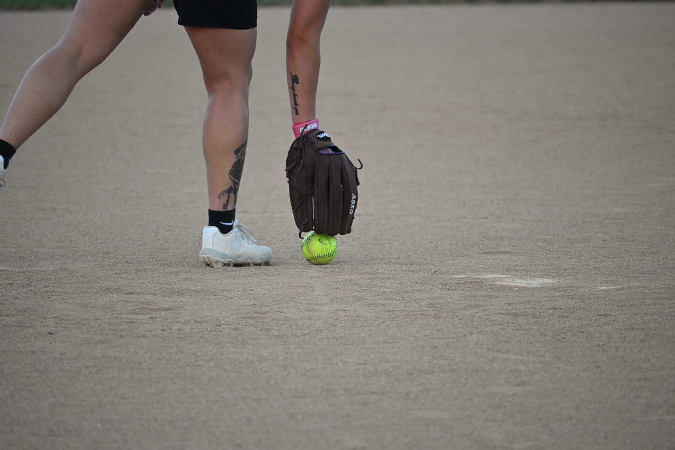 Baseball on a dark surface, with visible stitching.