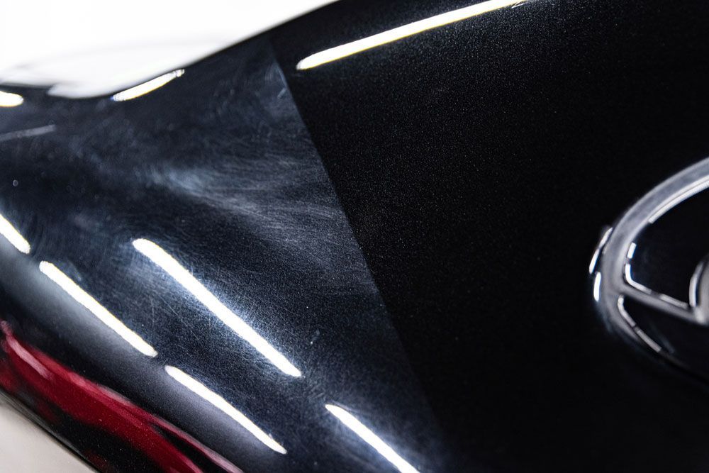 A close up of a black car with a mercedes logo on it