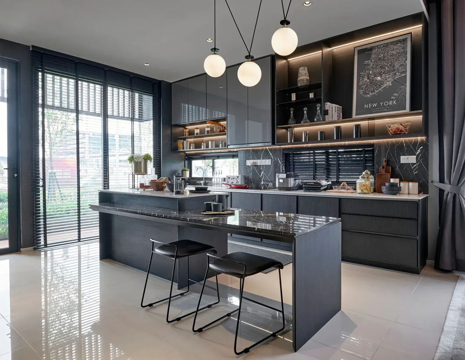 Modern kitchen with gray cabinets, island with stools, large windows, and pendant lights.