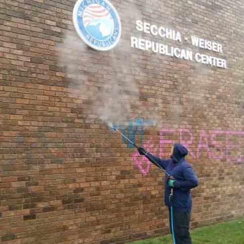 Pressure washing on a brick wall