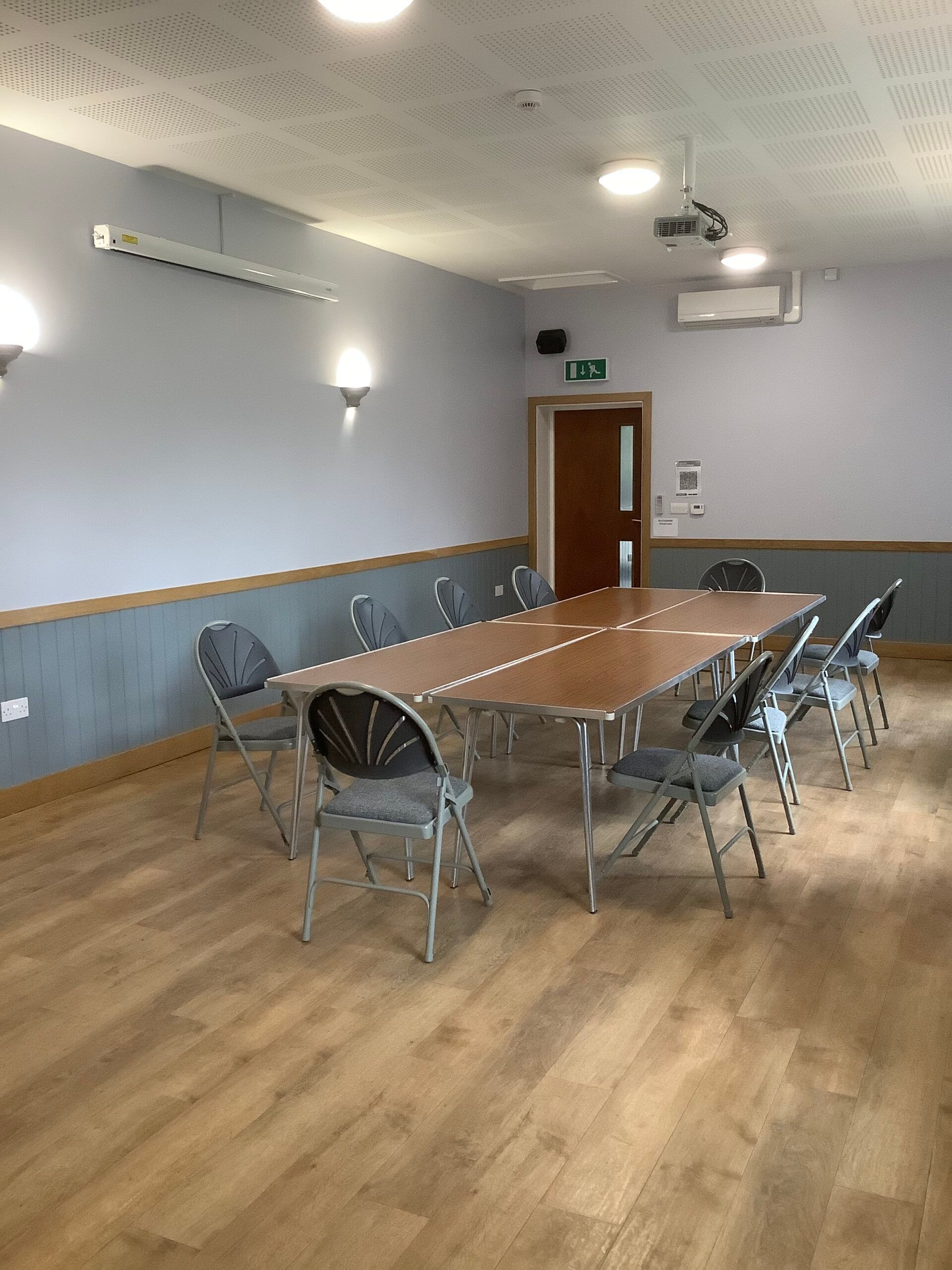 A conference room with a long table and chairs.