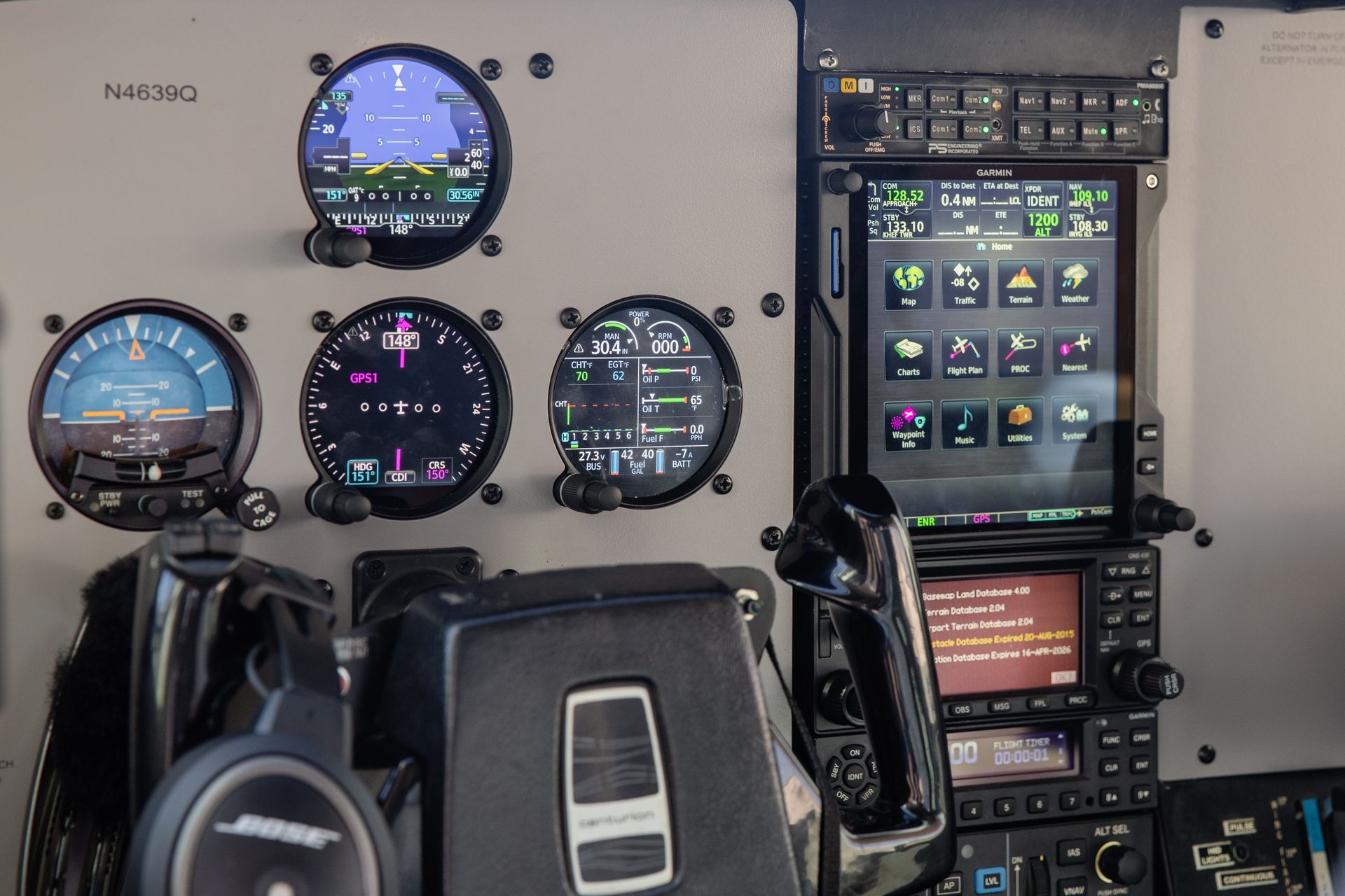 Aircraft cockpit with multiple round gauges and a touchscreen display panel