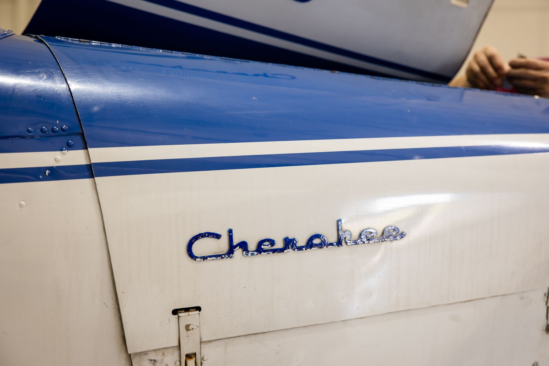 Blue and white vintage aircraft fuselage with the word