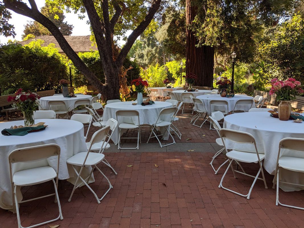 A patio with tables and chairs set up for a party.