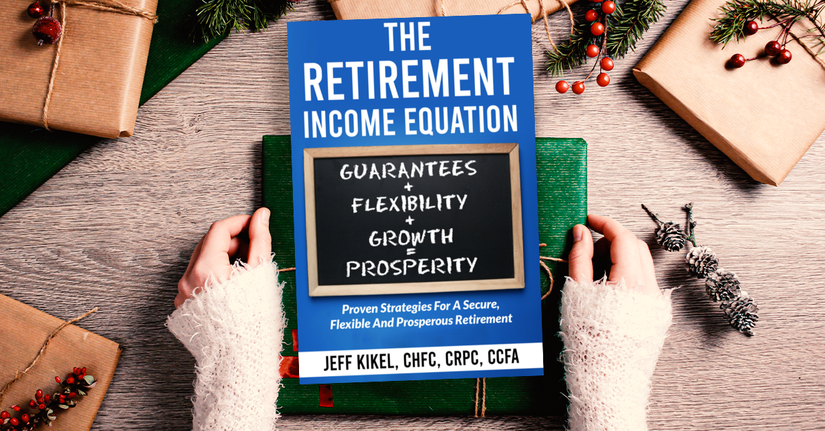 A person is holding a book titled the retirement income equation.
