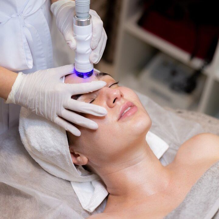 A woman is getting a facial treatment at a spa