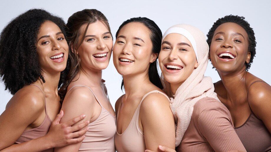 A group of women are posing for a picture together and smiling.