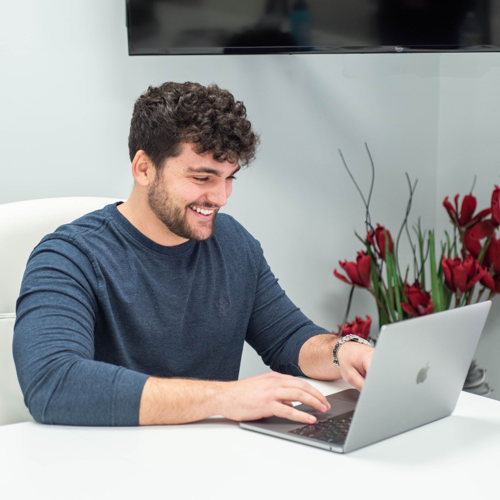 Ashley Lay Real Estate team member smiling at his desk
