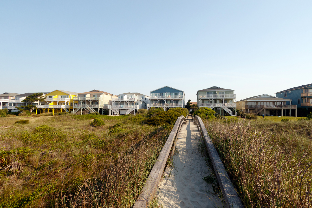Row of beach houses representing vacation rental investment properties