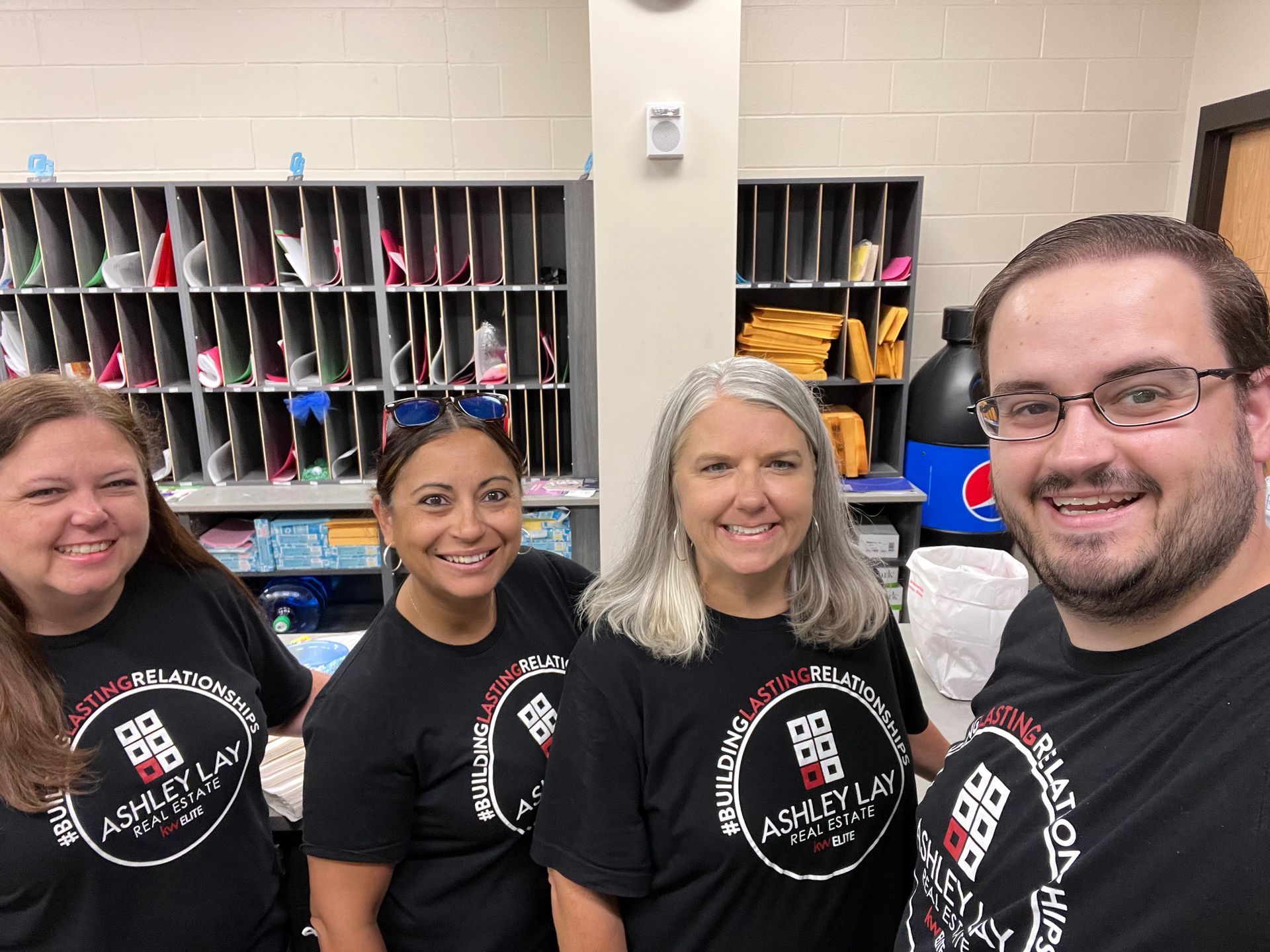 Ashley Lay Real Estate team members wearing company shirts at a community event