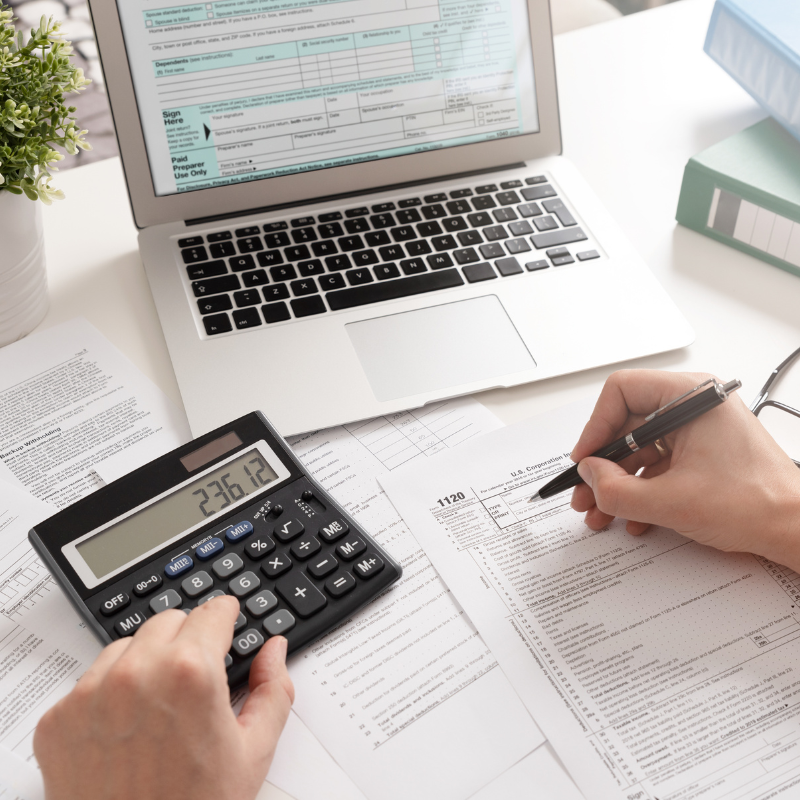 Laptop and financial documents representing real estate investment planning
