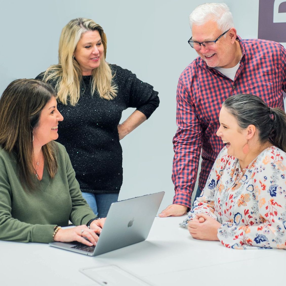 Ashley Lay Real Estate team members collaborating together at the office