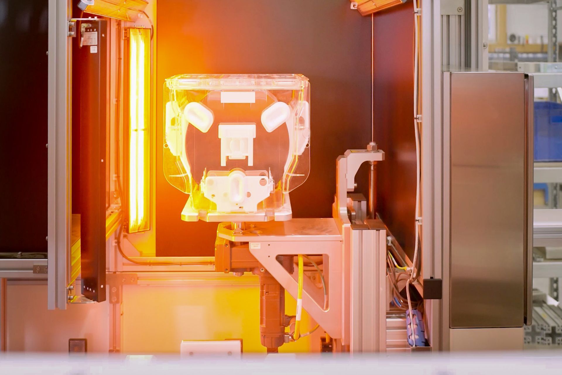 Eine Nahaufnahme eines Kunststoffbehälters/FOSB in einer Maschine, auf die ein Licht scheint.
