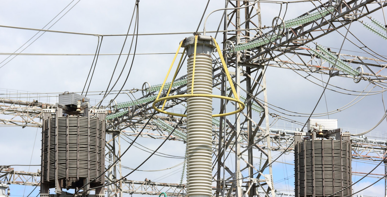 A power plant with a lot of wires hanging from it.
