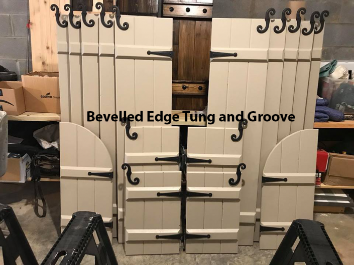 Display of beige beveled-edge tongue-and-groove panels with black wrought-iron hardware￼
